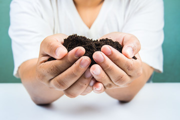  soil  in hands on white background.