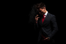 Young Business Man Is Thinking While Smoking His Cigarette