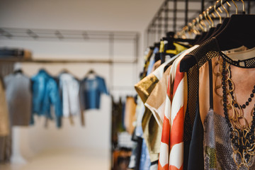 Clothes on hangers in a retail shop