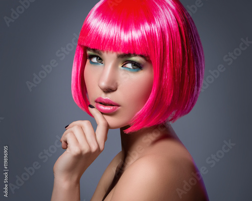 Fototapeta na wymiar Potrait of young woman with pink hair