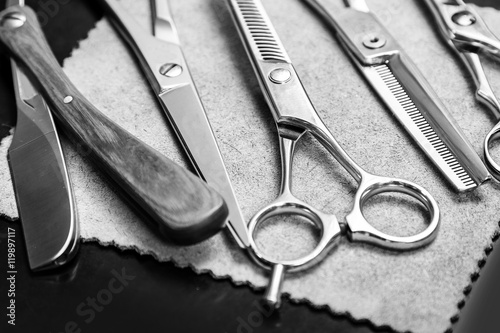 Fototapeta na wymiar Straight razor and different scissors