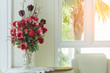 vase of red rose in white living room