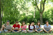 © Africa Studio - Young people with gadgets in a park