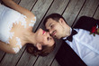 © johoo - Beautiful bride and groom enjoy a sunny day while lying down on