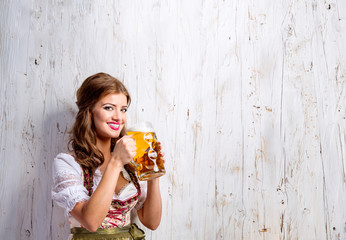 Wall Mural - Woman in traditional bavarian dress drinking beer