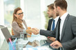 © ASDF - Happy business partners shaking hands in an office