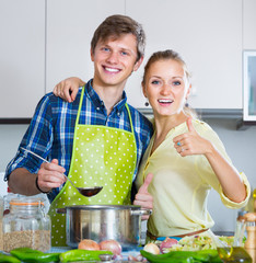 Wall Mural - Positive married couple cooking vegetable soup