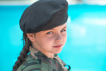 Wall Mural - Young girl in army ammunition