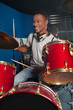© stockyimages - Drummer man playing on drums studio shot