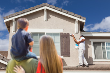 Wall Mural - Young Family Watching Home Get Painted by Professional House Painter.