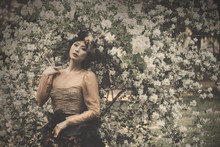 Asian Woman In Beautiful Vintage Dress Posing On Floral Background