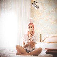 Woman On Bed With Cup Of Tea Or Coffee On Head