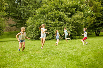 Poster - happy kids running and playing game outdoors