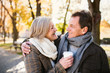 © Halfpoint - Beautiful senior couple hugging in park, drinking coffee. Autumn