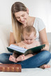 © Kyrylo Ryzhov - Smiling mother and her 9 months old baby boy sitting on sofa and
