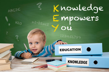 KEY - Knowledge Empowers You. Young boy sitting at the office de