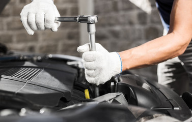 Mechanic working in auto repair garage. Car maintenance