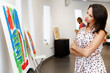 © Sergey Nivens - Young caucasian woman standing in art gallery front of  paintings