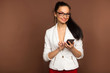 © dubogray1985 - beautiful brunette in glasses and a business suit with a mobile