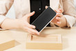 © golubovy - Female hands holding new smartphone. Customer taking gadget from post package. Recent model of phone delivery