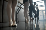 Dancers stands by the ballet barre.