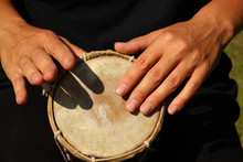 Close Up Of Hands Of A Woman Playing A Drum