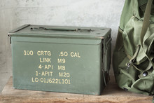 Still Life Photography : Old And Dusty Bullet Box ( Ammo Crate ) With Part Of Military Backpack On Old Wood
