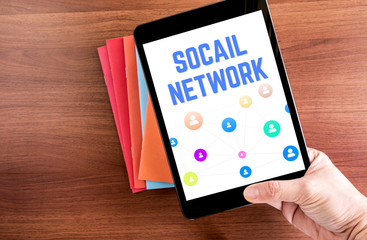 Poster - top view of hand holding tablet with social network word over co