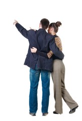 Wall Mural - Young couple pointing at wall. Rear view. Isolated over white background.