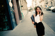 © NDABCREATIVITY - Businesswoman using phone outdoors