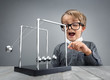 © Brian Jackson - Physics and science education boy with Newton's cradle