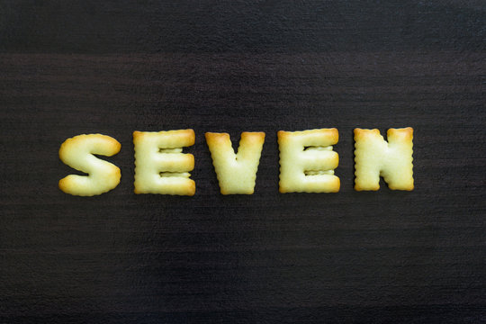message written with letter biscuits, on wood background/cookie letter alphabet on wood background/creativity word written with homemade biscuits, on wood background