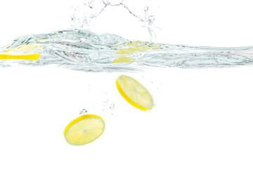 Wall Mural - Fresh lemon dropped into water with splash isolated on white