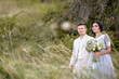 © ronedya - Young couple in love outdoor. Elegant bride and groom posing together outdoors on a wedding day. bride and groom in the Park. young couple in the woods. young couple in the grass. couple walking