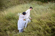 © ronedya - Young couple in love outdoor. Elegant bride and groom posing together outdoors on a wedding day. bride and groom in the Park. young couple in the woods. young couple in the grass. couple walking