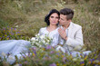 © ronedya - Young couple in love outdoor. Elegant bride and groom posing together outdoors on a wedding day. bride and groom in the Park. young couple in the woods. young couple in the grass. couple walking