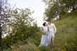 © ronedya - Young couple in love outdoor. Elegant bride and groom posing together outdoors on a wedding day. bride and groom in the Park. young couple in the woods. young couple in the grass. couple walking