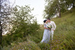 © ronedya - Young couple in love outdoor. Elegant bride and groom posing together outdoors on a wedding day. bride and groom in the Park. young couple in the woods. young couple in the grass. couple walking