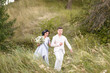 © ronedya - Young couple in love outdoor. Elegant bride and groom posing together outdoors on a wedding day. bride and groom in the Park. young couple in the woods. young couple in the grass. couple walking