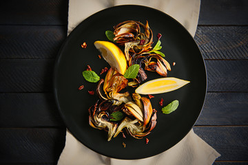 Sticker - Baked artichokes with spices on wooden background