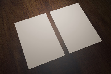 Two paper sheets on wood