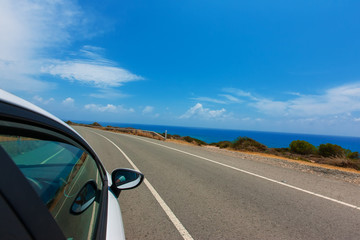 Wall Mural - 3..white car driving by autobahn on the coast of the Mediterrane