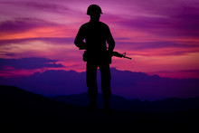 Silhouette Of Combat Soldier Circa Vietnam War Era. Set Against Nice Purple Sunset Background.