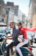 © jackfrog - Trendy young couple riding a scooter in the streets