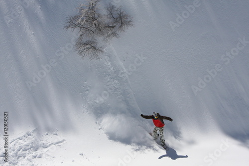 Fotografie, Obraz Snowboarding Down the Snowy Mountain Terrain at the Ski Resort at Nevados De Chi