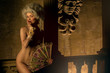 Half-naked Victorian lady. Young woman in eighteenth century image posing in vintage interior