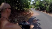 Man Riding A Moped Through The Village