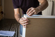 © funkyfrogstock - Unrecognizable person assembling furniture
