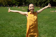 © blvdone - Asian woman in a city park spreading arms