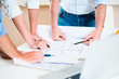 © Kzenon - Discussion of construction plans in architects office